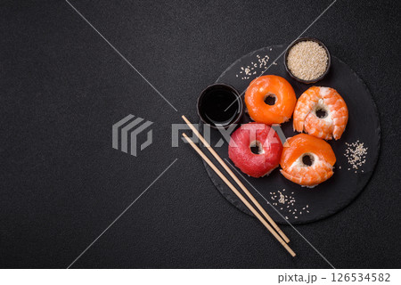 Donut shaped sushi rolls with salmon, shrimp and tuna 126534582