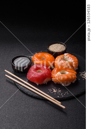 Donut shaped sushi rolls with salmon, shrimp and tuna 126534583