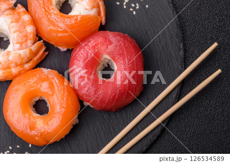 Donut shaped sushi rolls with salmon, shrimp and tuna 126534589