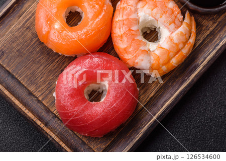 Donut shaped sushi rolls with salmon, shrimp and tuna 126534600