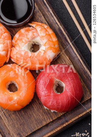 Donut shaped sushi rolls with salmon, shrimp and tuna 126534605