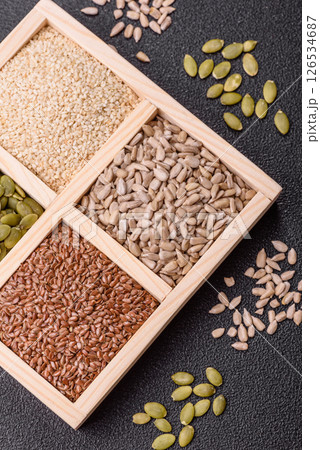 Sunflower, pumpkin, flax and sesame seeds in a wooden box Sunflower, pumpkin, flax and sesame seeds in a wooden box 126534687