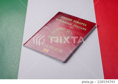Italian citizen passport against the background of the national flag of Italy Italian citizen passport against the background of the national flag of Italy 126534743