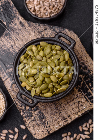 Peeled pumpkin seeds in a bowl, an ingredient for making vegetarian food Peeled pumpkin seeds in a bowl, an ingredient for making vegetarian food 126534975