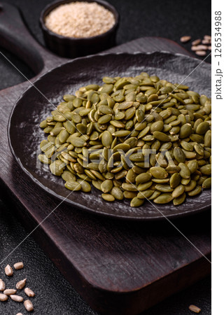 Peeled pumpkin seeds in a bowl, an ingredient for making vegetarian food Peeled pumpkin seeds in a bowl, an ingredient for making vegetarian food 126534988