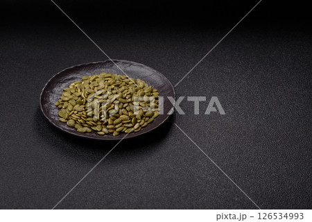Peeled pumpkin seeds in a bowl, an ingredient for making vegetarian food Peeled pumpkin seeds in a bowl, an ingredient for making vegetarian food 126534993