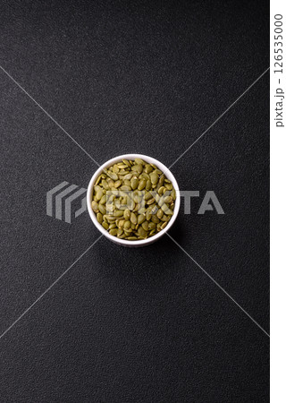 Peeled pumpkin seeds in a bowl, an ingredient for making vegetarian food Peeled pumpkin seeds in a bowl, an ingredient for making vegetarian food 126535000