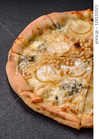 Delicious sweet pizza with pear, gorgonzola cheese and nuts Delicious sweet pizza with pear, gorgonzola cheese and nuts 126535021