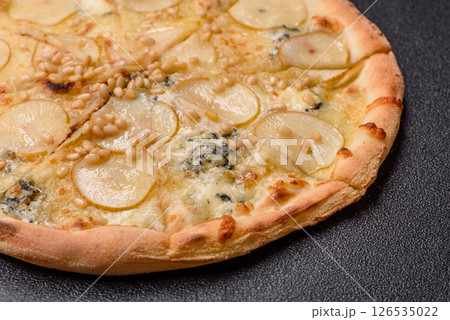 Delicious sweet pizza with pear, gorgonzola cheese and nuts Delicious sweet pizza with pear, gorgonzola cheese and nuts 126535022