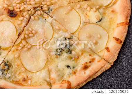 Delicious sweet pizza with pear, gorgonzola cheese and nuts Delicious sweet pizza with pear, gorgonzola cheese and nuts 126535023