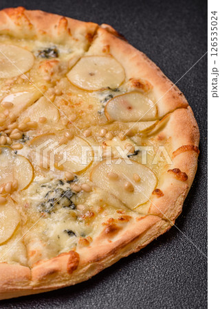 Delicious sweet pizza with pear, gorgonzola cheese and nuts 126535024