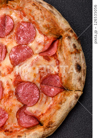 Pepperoni pizza with sausage, cheese, tomatoes, salt and spices 126535056
