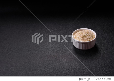 White sesame seeds in a bowl, an ingredient for making vegetarian food White sesame seeds in a bowl, an ingredient for making vegetarian food 126535066