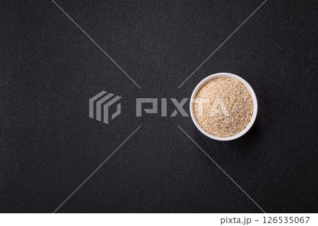 White sesame seeds in a bowl, an ingredient for making vegetarian food White sesame seeds in a bowl, an ingredient for making vegetarian food 126535067