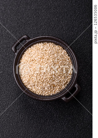 White sesame seeds in a bowl, an ingredient for making vegetarian food White sesame seeds in a bowl, an ingredient for making vegetarian food 126535086
