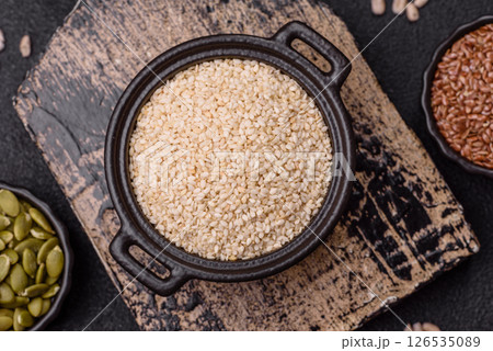 White sesame seeds in a bowl, an ingredient for making vegetarian food White sesame seeds in a bowl, an ingredient for making vegetarian food 126535089