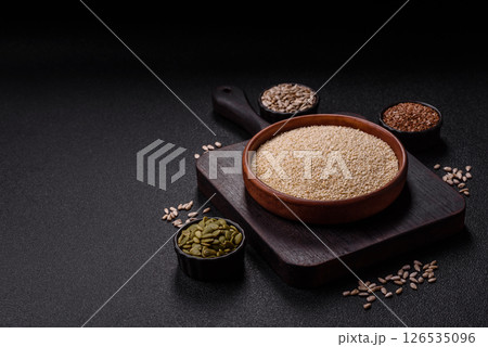 White sesame seeds in a bowl, an ingredient for making vegetarian food White sesame seeds in a bowl, an ingredient for making vegetarian food 126535096