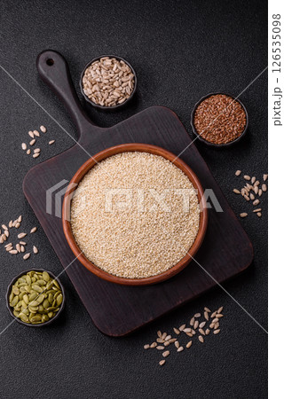 White sesame seeds in a bowl, an ingredient for making vegetarian food White sesame seeds in a bowl, an ingredient for making vegetarian food 126535098
