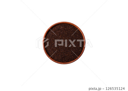 Black tea dry crushed in bowl 126535124