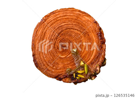 Round puff pastry croissant with pistachio filling or new york roll 126535146