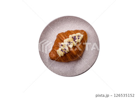 Sweet crispy fresh croissant with berry filling 126535152