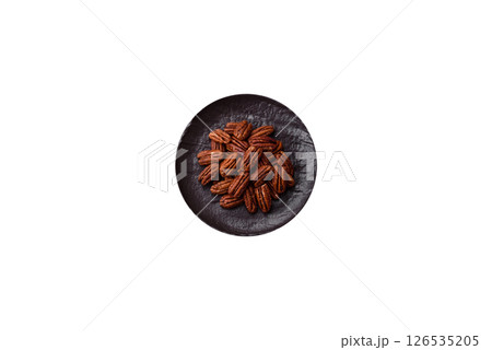 Nut, pecans in a ceramic bowl, an ingredient in vegan food 126535205