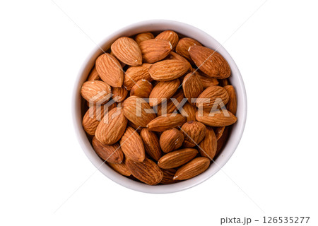 Roasted or raw peeled almonds in bowl 126535277