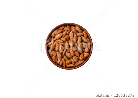 Roasted or raw almond nuts in shell in bowl Roasted or raw almond nuts in shell in bowl 126535278
