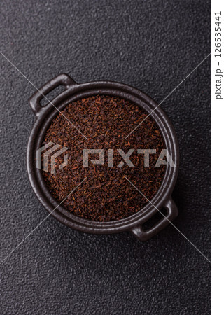 Black tea dry crushed in bowl 126535441