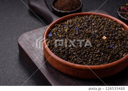 Dry green tea with soursop piece, knapweed petals in bowl 126535488