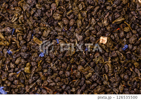Dry green tea with soursop piece, knapweed petals in bowl 126535500