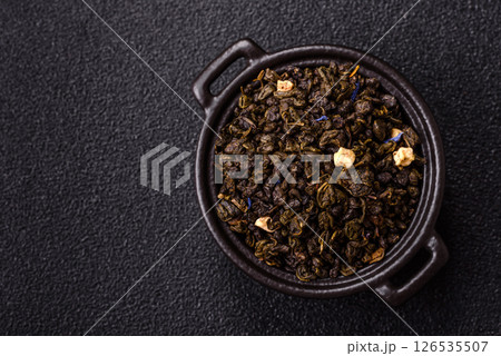 Dry green tea with soursop piece, knapweed petals in bowl Dry green tea with soursop piece, knapweed petals in bowl 126535507