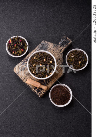 Dry green tea with soursop piece, knapweed petals in bowl 126535528