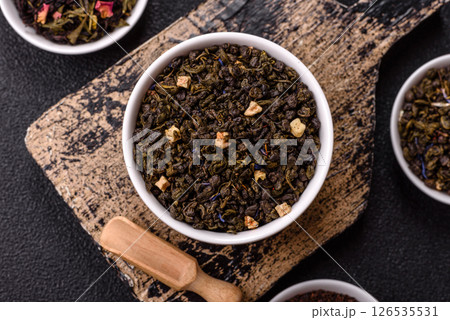 Dry green tea with soursop piece, knapweed petals in bowl 126535531