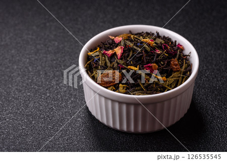 Dry tea mix blend black, green and flower petals in bowl Dry tea mix blend black, green and flower petals in bowl 126535545