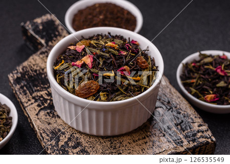 Dry tea mix blend black, green and flower petals in bowl 126535549