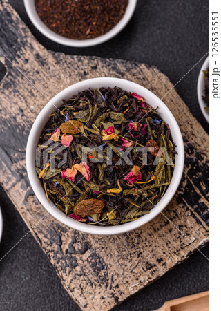 Dry tea mix blend black, green and flower petals in bowl 126535551