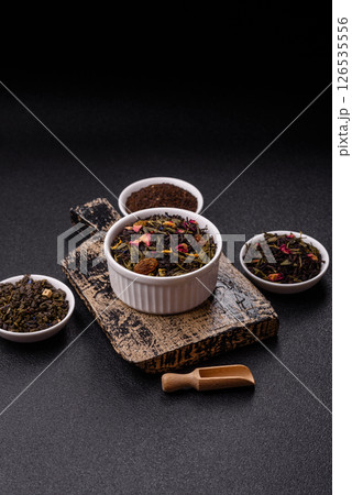 Dry tea mix blend black, green and flower petals in bowl 126535556