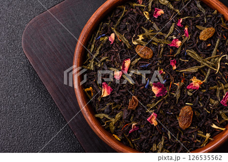 Dry tea mix blend black, green and flower petals in bowl Dry tea mix blend black, green and flower petals in bowl 126535562