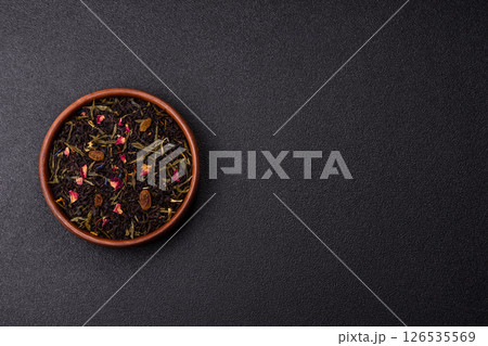 Dry tea mix blend black, green and flower petals in bowl 126535569