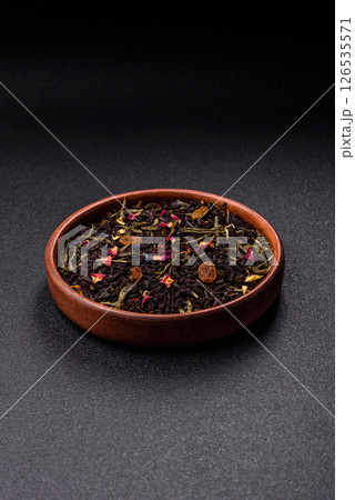 Dry tea mix blend black, green and flower petals in bowl 126535571