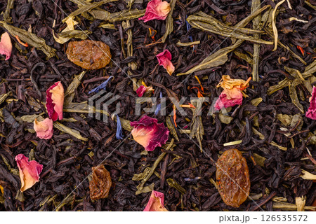 Dry tea mix blend black, green and flower petals in bowl Dry tea mix blend black, green and flower petals in bowl 126535572