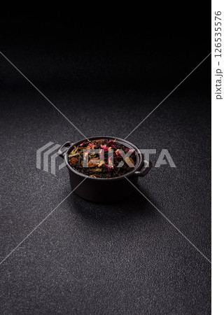 Dry tea mix blend black, green and flower petals in bowl 126535576