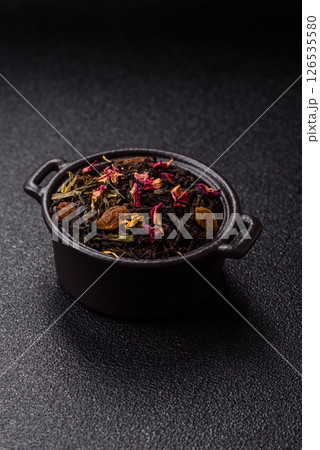 Dry tea mix blend black, green and flower petals in bowl 126535580