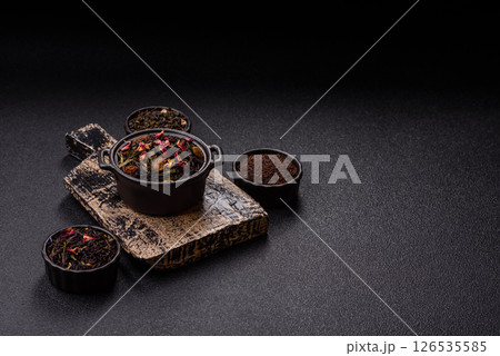 Dry tea mix blend black, green and flower petals in bowl 126535585
