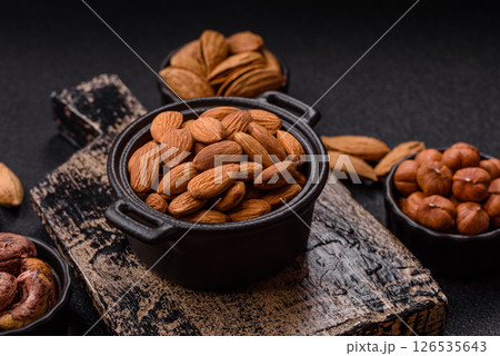 Roasted or raw peeled almonds in bowl 126535643