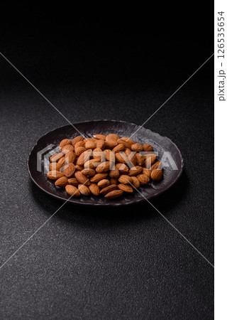 Roasted or raw peeled almonds in bowl Roasted or raw peeled almonds in bowl 126535654