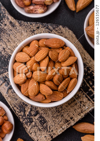 Roasted or raw peeled almonds in bowl 126535677