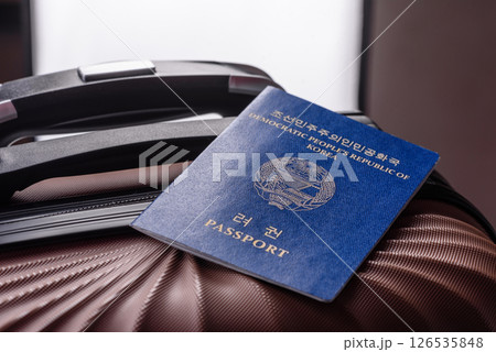 International passport of a citizen of North Korea on a suitcase International passport of a citizen of North Korea on a suitcase 126535848
