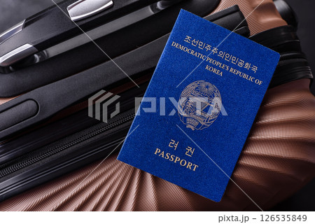 International passport of a citizen of North Korea on a suitcase International passport of a citizen of North Korea on a suitcase 126535849